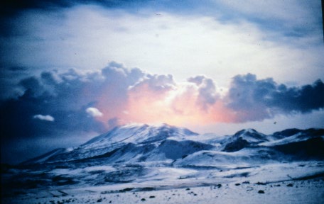 Mount Hekla with a glow reflected in the clouds